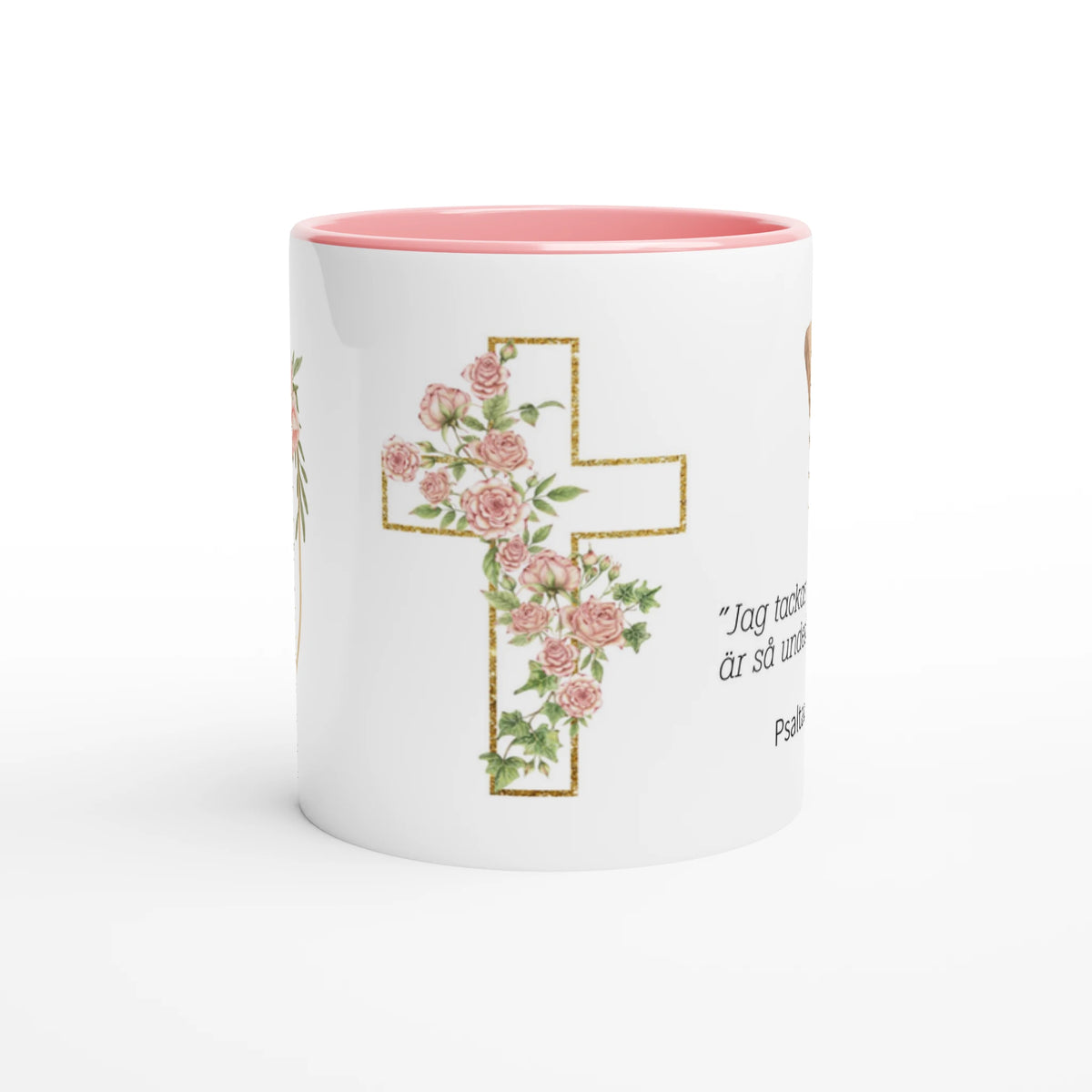 Vit keramikmugg med rosa insida, blommigt kors på sidan av muggen.
